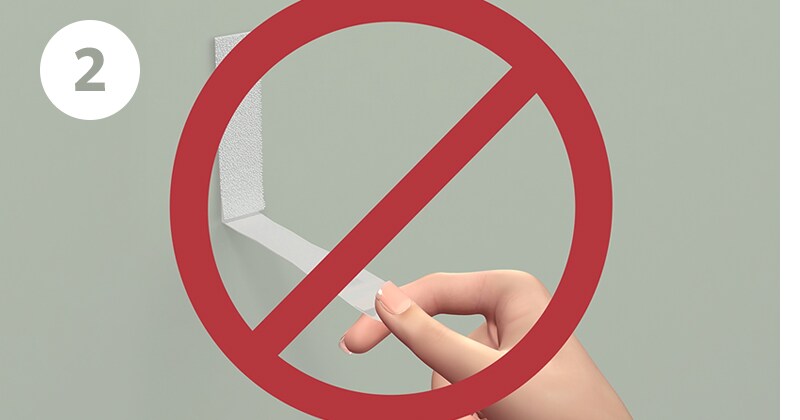Step 2 - Always pull straight down on the Command strip, never pull away from wall.
