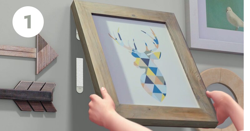 Step 1 - Grab bottom corners and peel frame from wall. Do not pull straight off.
